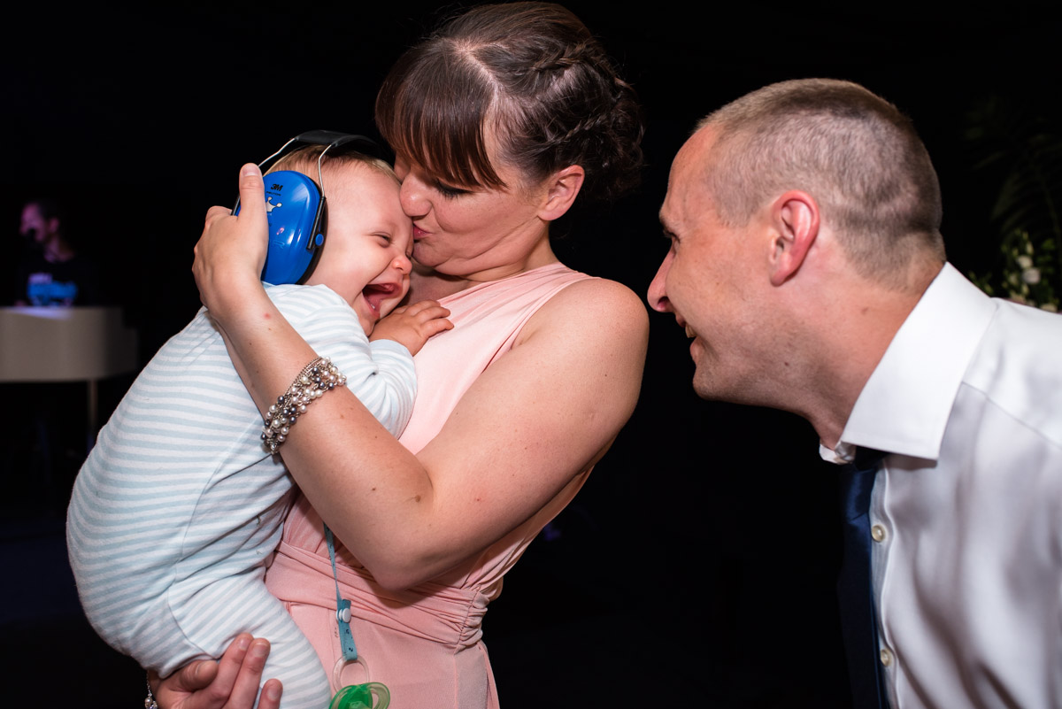 Baby Hugo wears ear protectors during the wedding dance