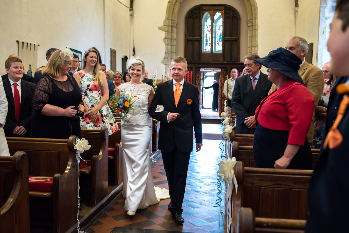Anias brother leads her into the church for her wedding to John, photographed by Helen Batt.