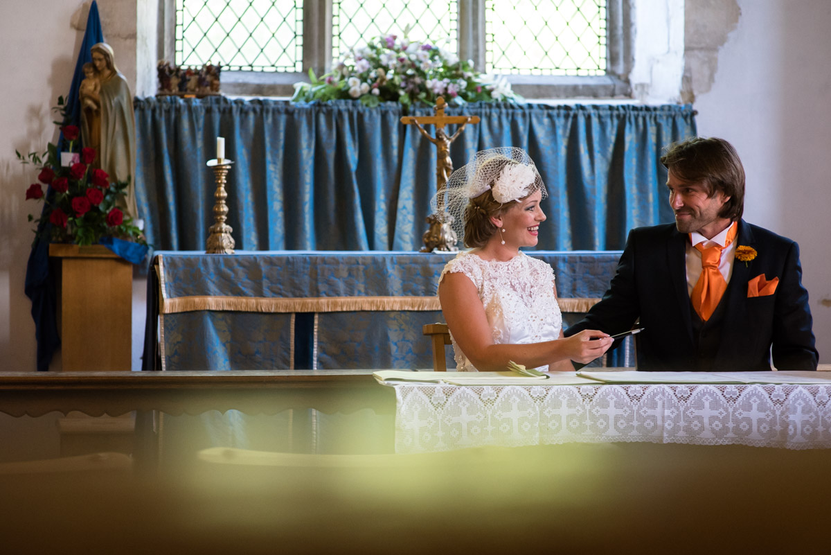 John & Ania signing the register after their Kent wedding ceremony in St Marys Church