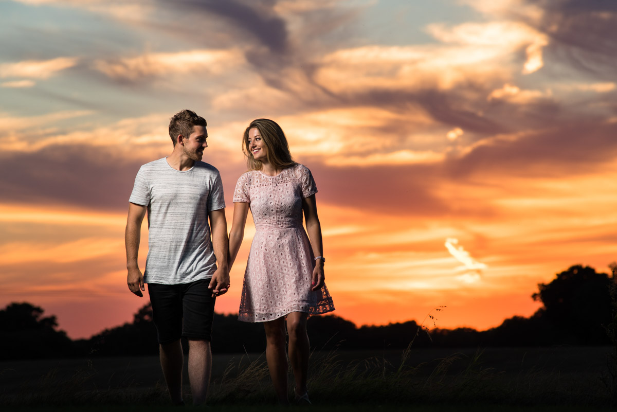 Jade and Stuart photographed walking together during their pre wedding photoshoot lit by off camera flash