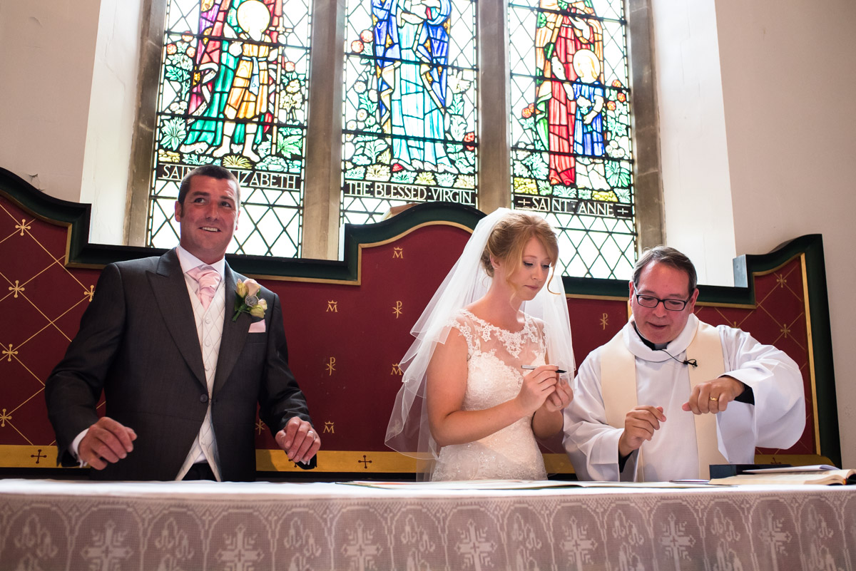 Kif and Becky sign the wedding register in Marden church in Kent
