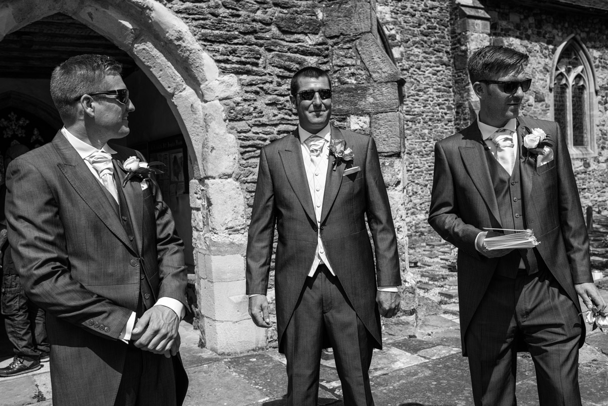 Black & White wedding photograph of Kif and his Best man outside Marden Church in Kent