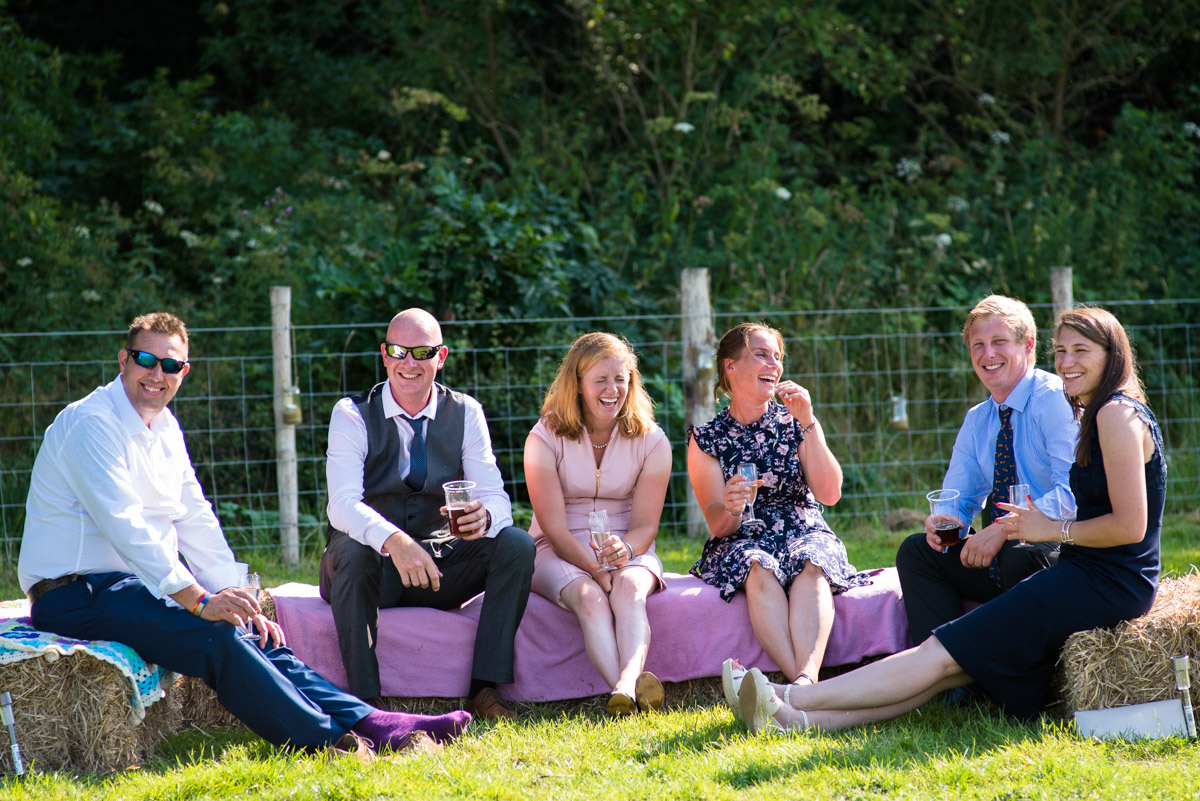 Photograph of Kif and Becky's wedding guests enjoying the summer sunshine in Kent