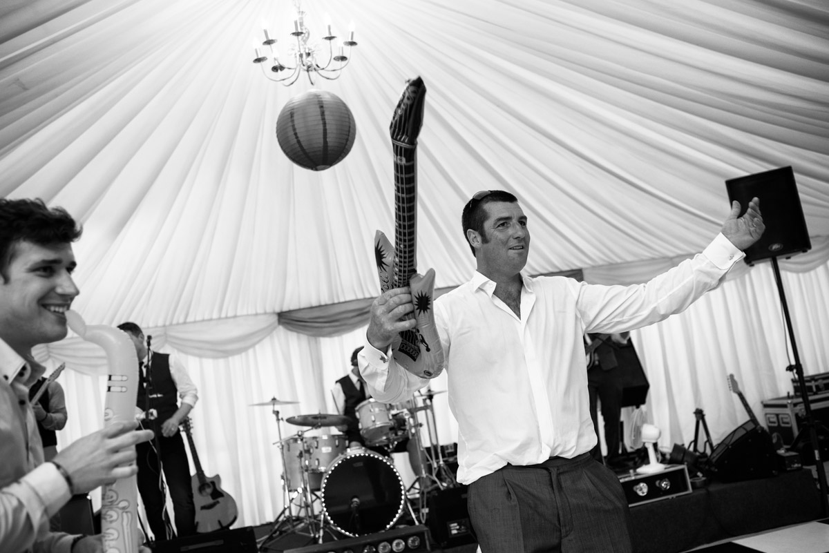 Kif is photographed with inflatable guitar dancing at his wedding reception in Kent
