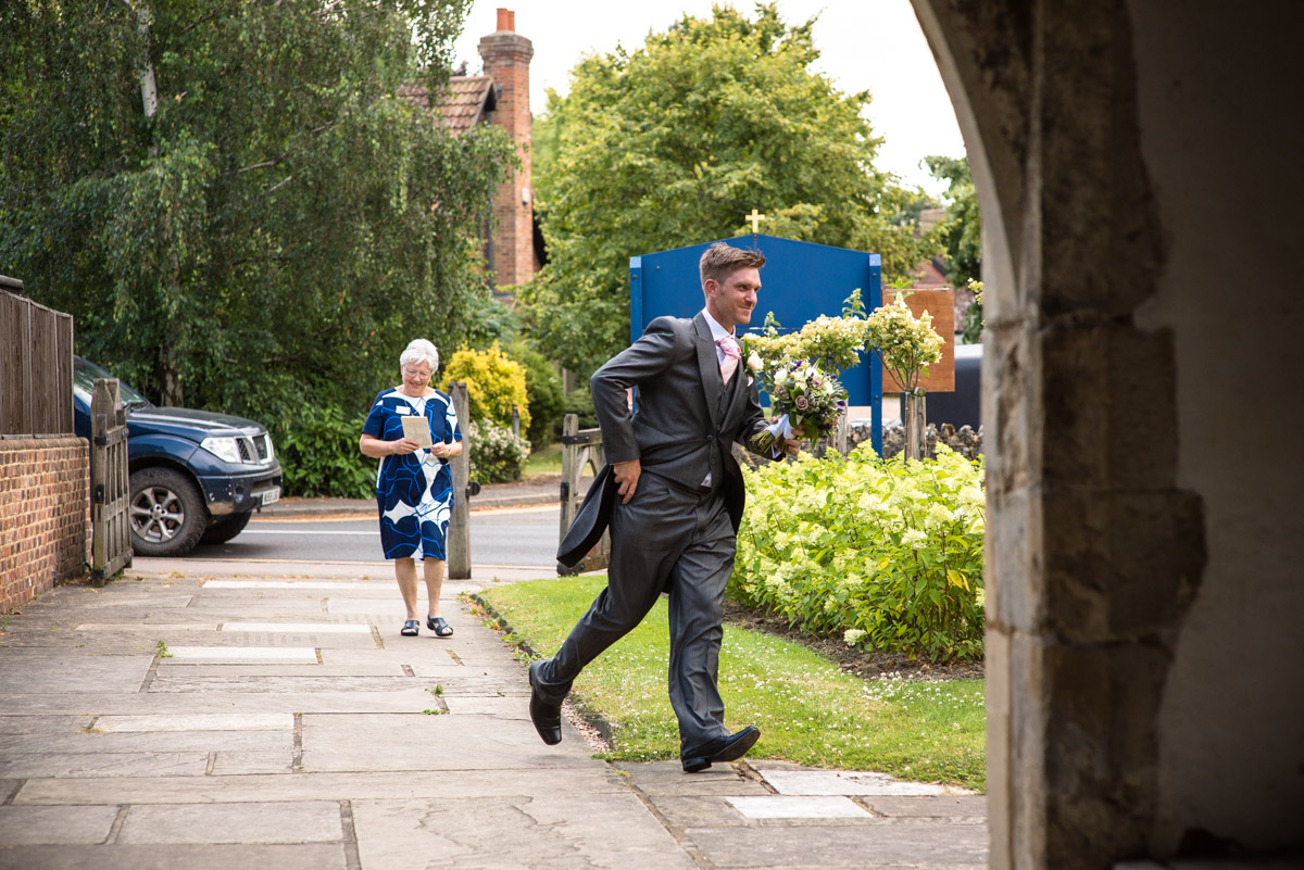 Photograph of Kif's usher running to the church with Becky's wedding bouquet