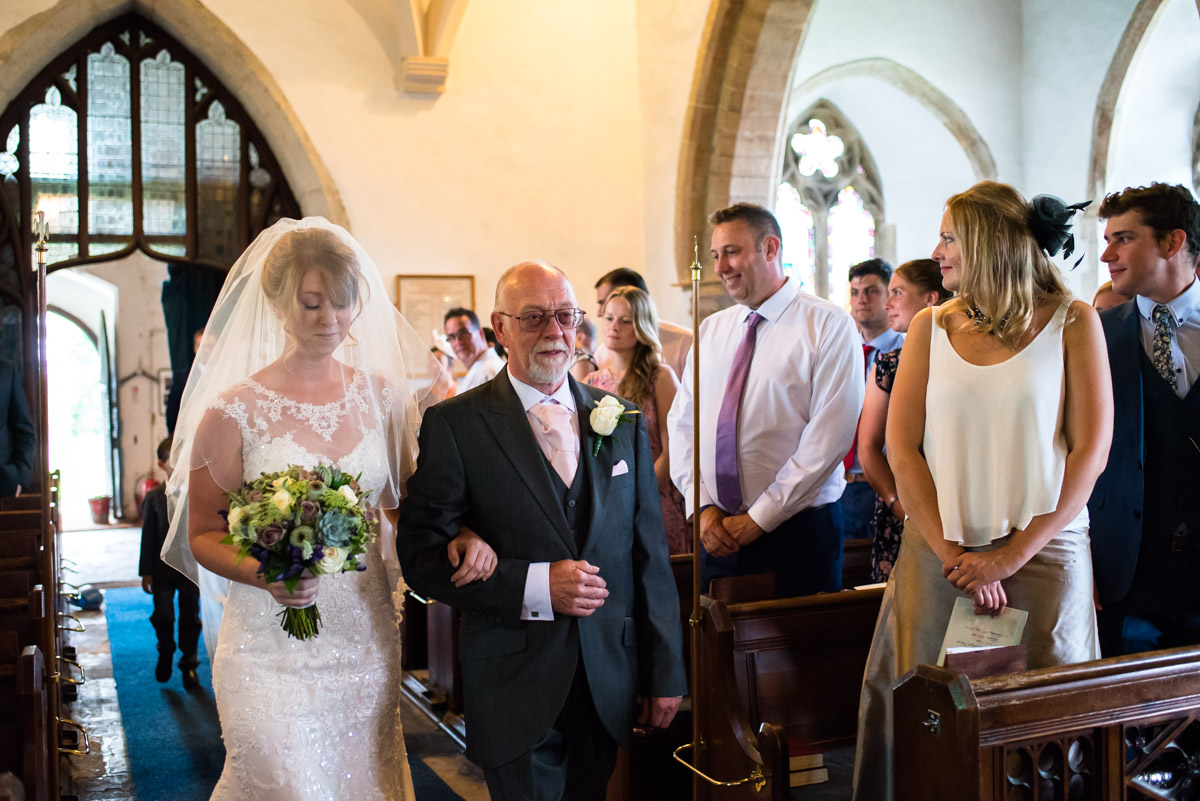 Becky is walked up the aisle by her father for her Kent wedding ceremony