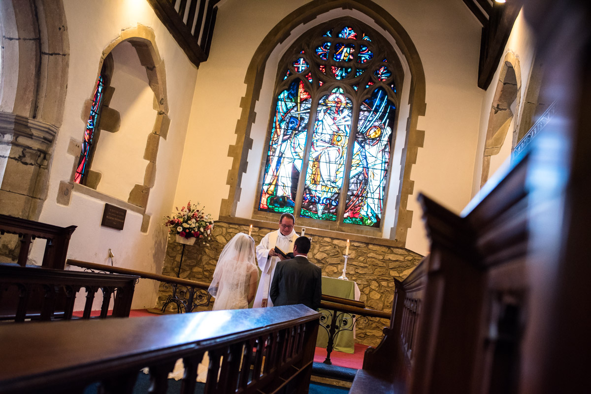 Photograph of Kif and Becky from the choir pews during the kent wedding ceremony