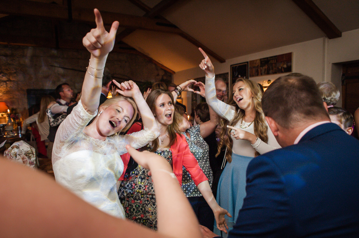 andrea and her wedding guests dancing at her wedding reception in the dering arms pub in pluckily, kent