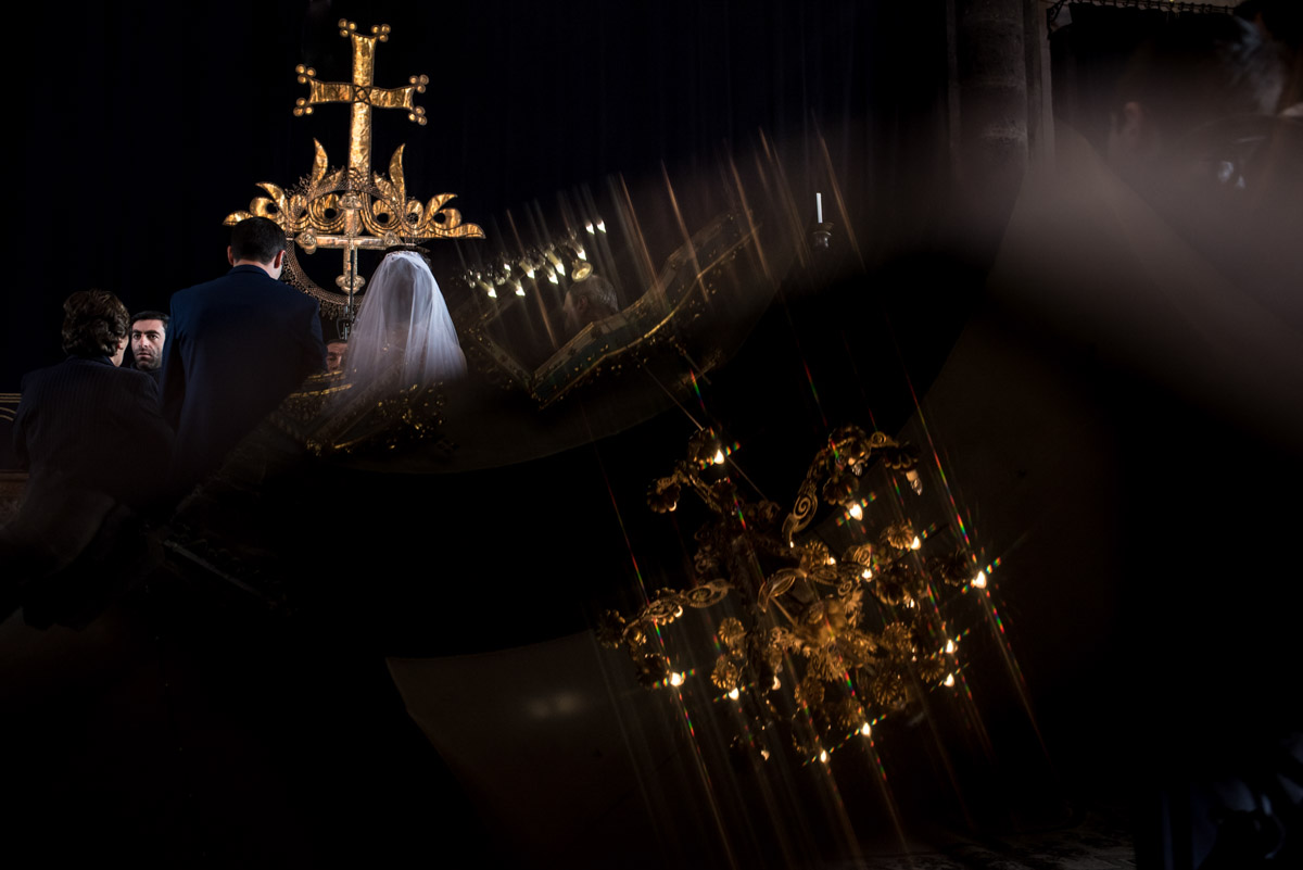 reflection of candelabra and bride and groom during their armenian wedding ceremony
