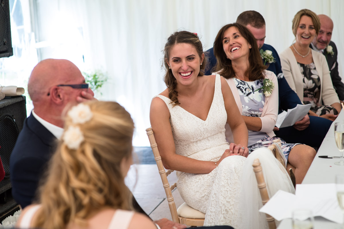 Ellie laughs with her dad during the wedding speeches
