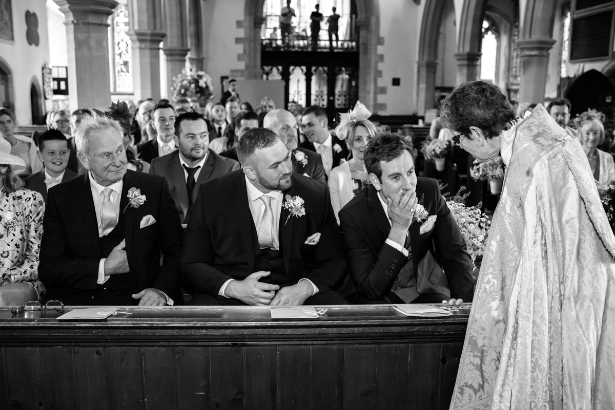 James is photographed as the vicar tells him the brides car has broken down