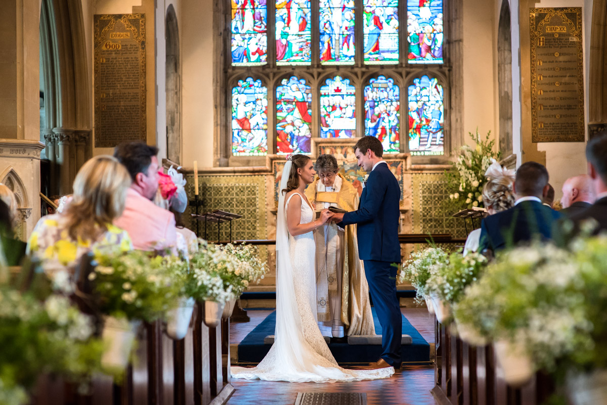James and Ellie exchange rings during their Kent church wedding