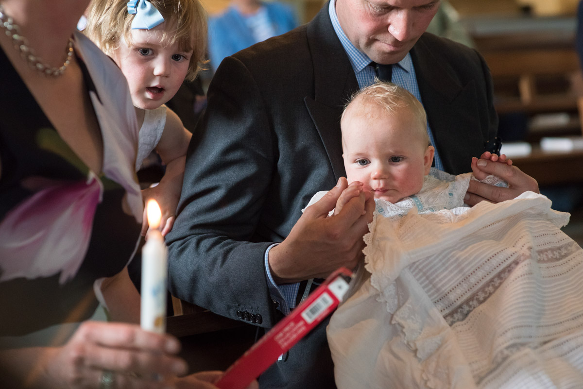 Baby Edward is photographed looking at Christening candle