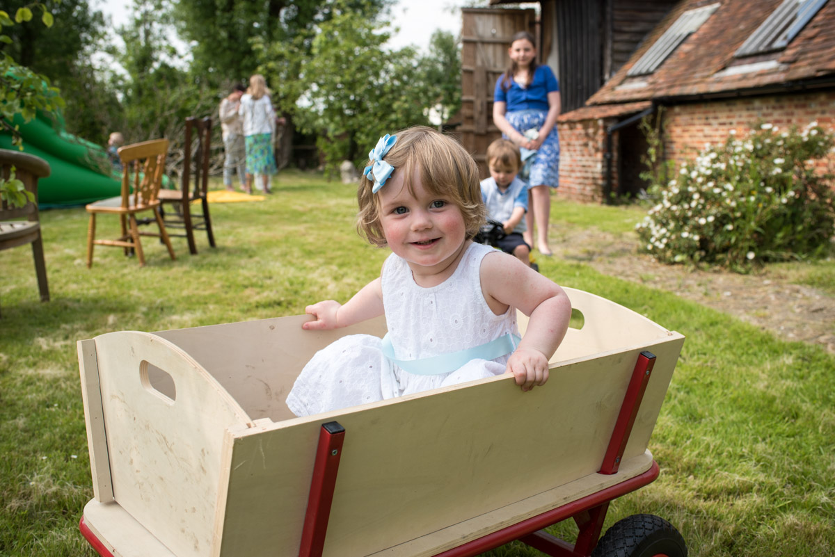 Beatrice is photographed sitting in wooden trailer in Kent garden