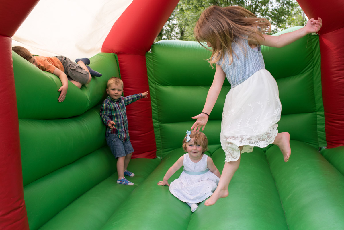 Photograph of children playing on bouncy castle in Harriets garden
