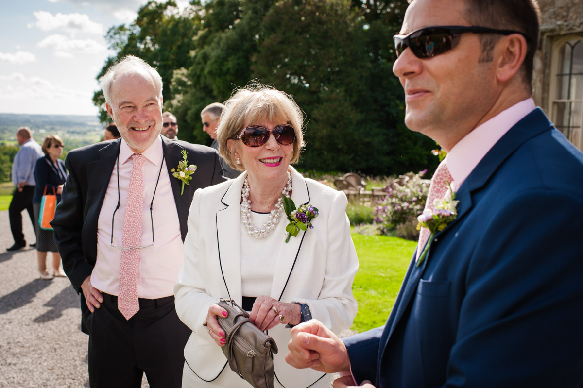 Groom and parents before wedding at Boughton Monchelsea Place in Kent