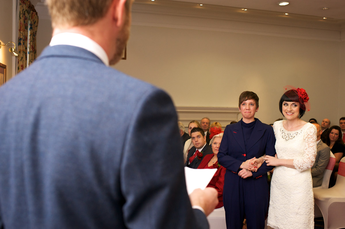 Anna and Robbie listen to the reading given during their civil partnership ceremony in London