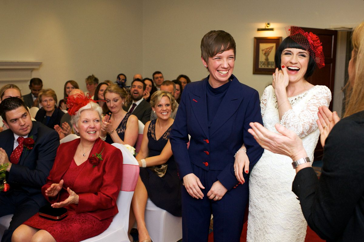Registra makes Anna and Robbie laugh during their civil partnership ceremony