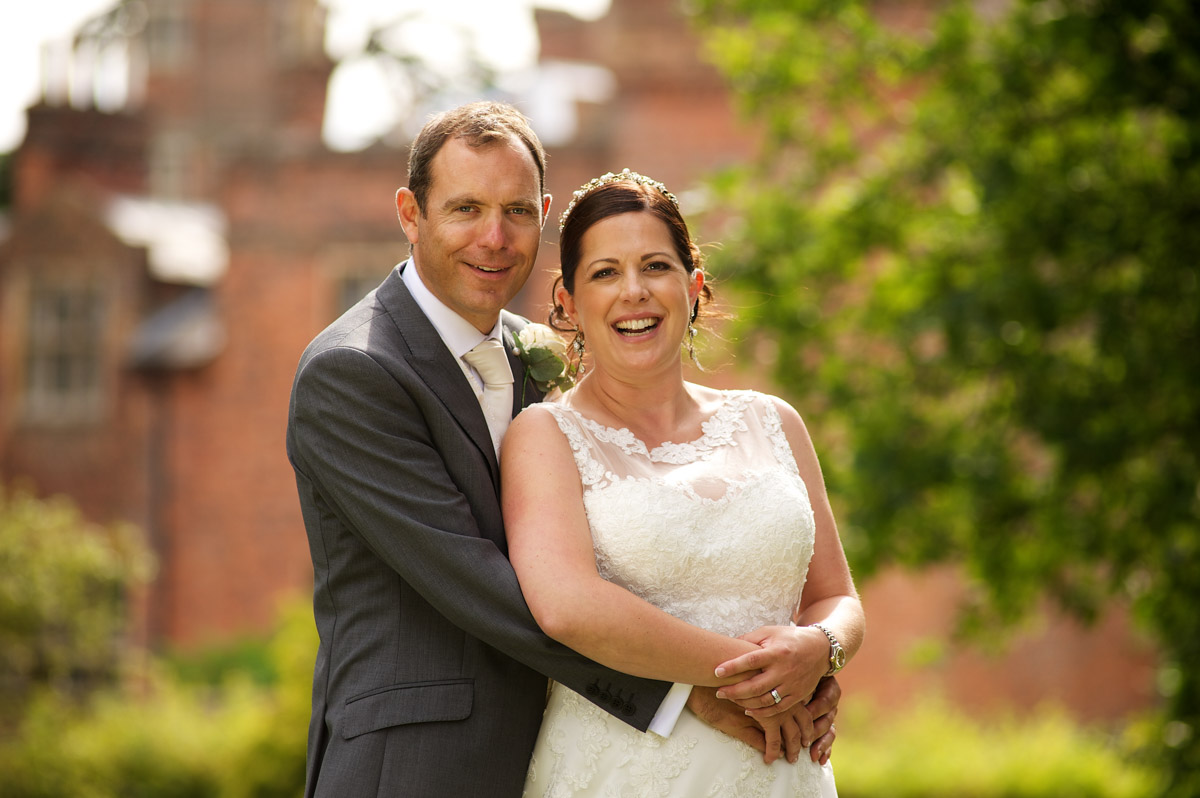 wedding photograph of tim and andrea on their wedding day posing outside cobham hall