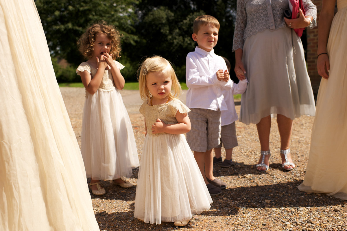 Flower girls and page boy wait for the start of andrea and Tims wedding at cobham hall in kent