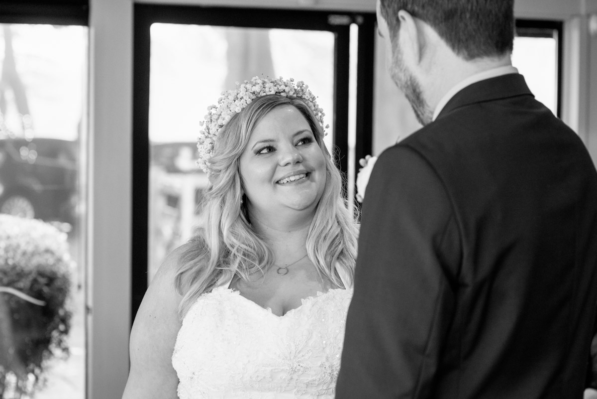 Stevie looks at her groom during their wedding ceremony at Crown Lodge in Kent