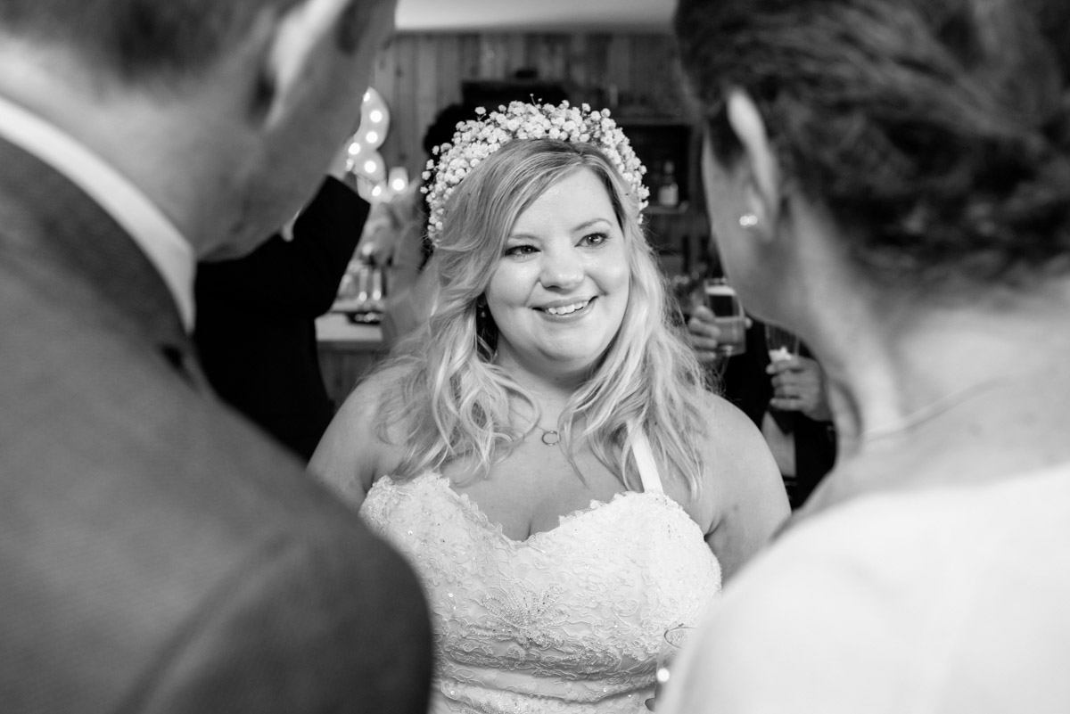 Photograph in black and white of Stevie on her wedding day enjoying the reception
