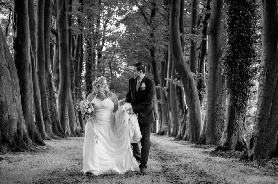 Black and white photograph of Lee and Stevie outside Crown Lodge on their wedding day