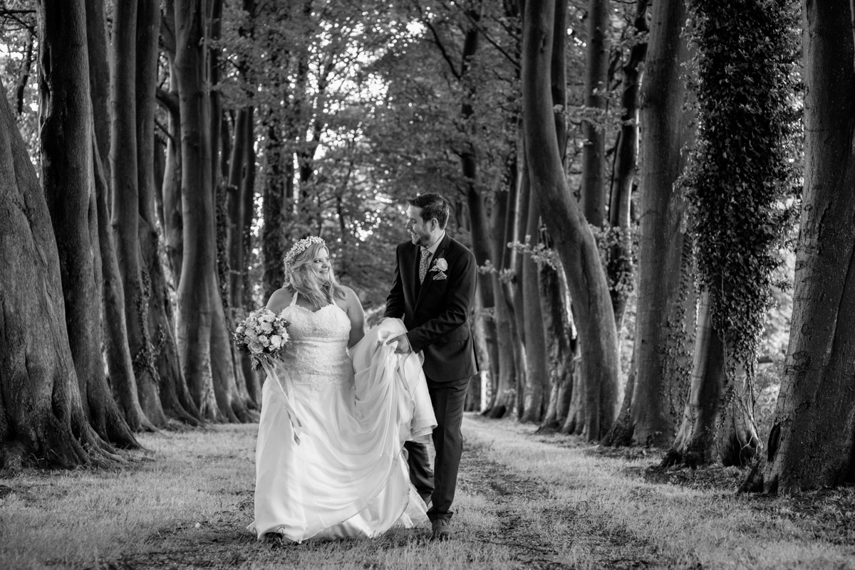 Black and white photograph of Lee and Stevie outside Crown Lodge on their wedding day