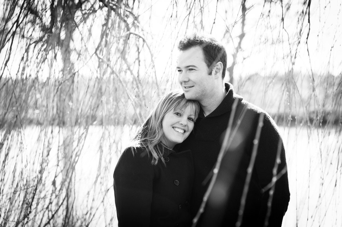 Couple portrait outside by willow tree, back and white, winter pre wedding photo shoot