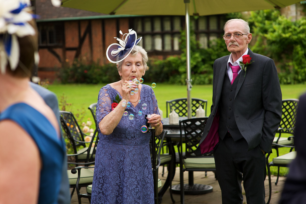 wedding guests blow bubbles during reception at never castle in kent