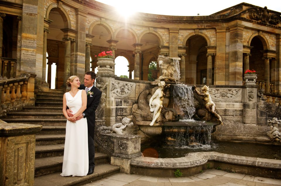 photograph of gail and john by the fountain in the italian gardens at hever castle after their wedding ceremony