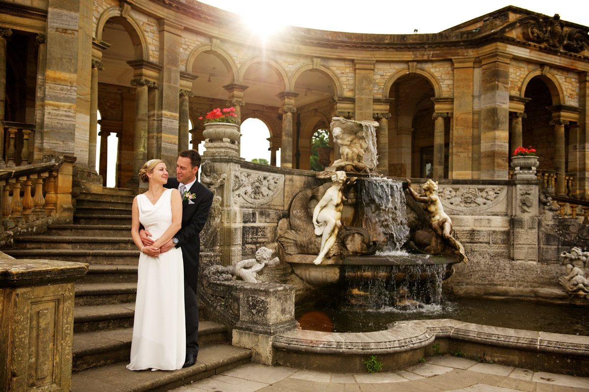 photograph of gail and john by the fountain in the italian gardens at hever castle after their wedding ceremony
