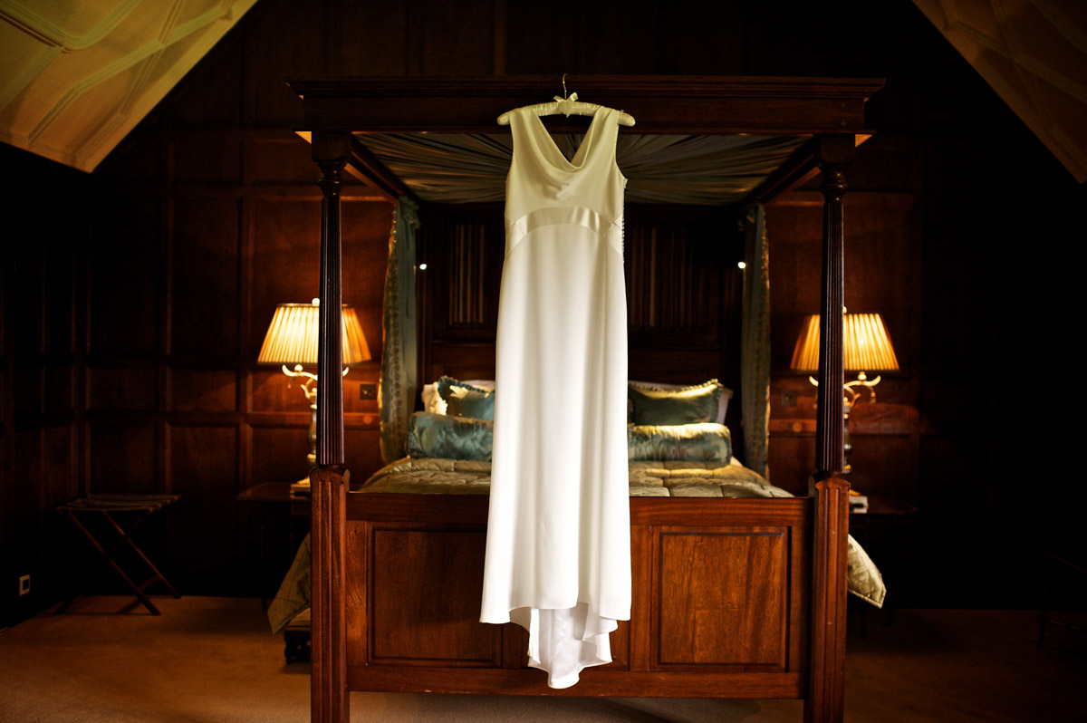 photograph of gains wedding dress hanging up on the bed in Hever castle
