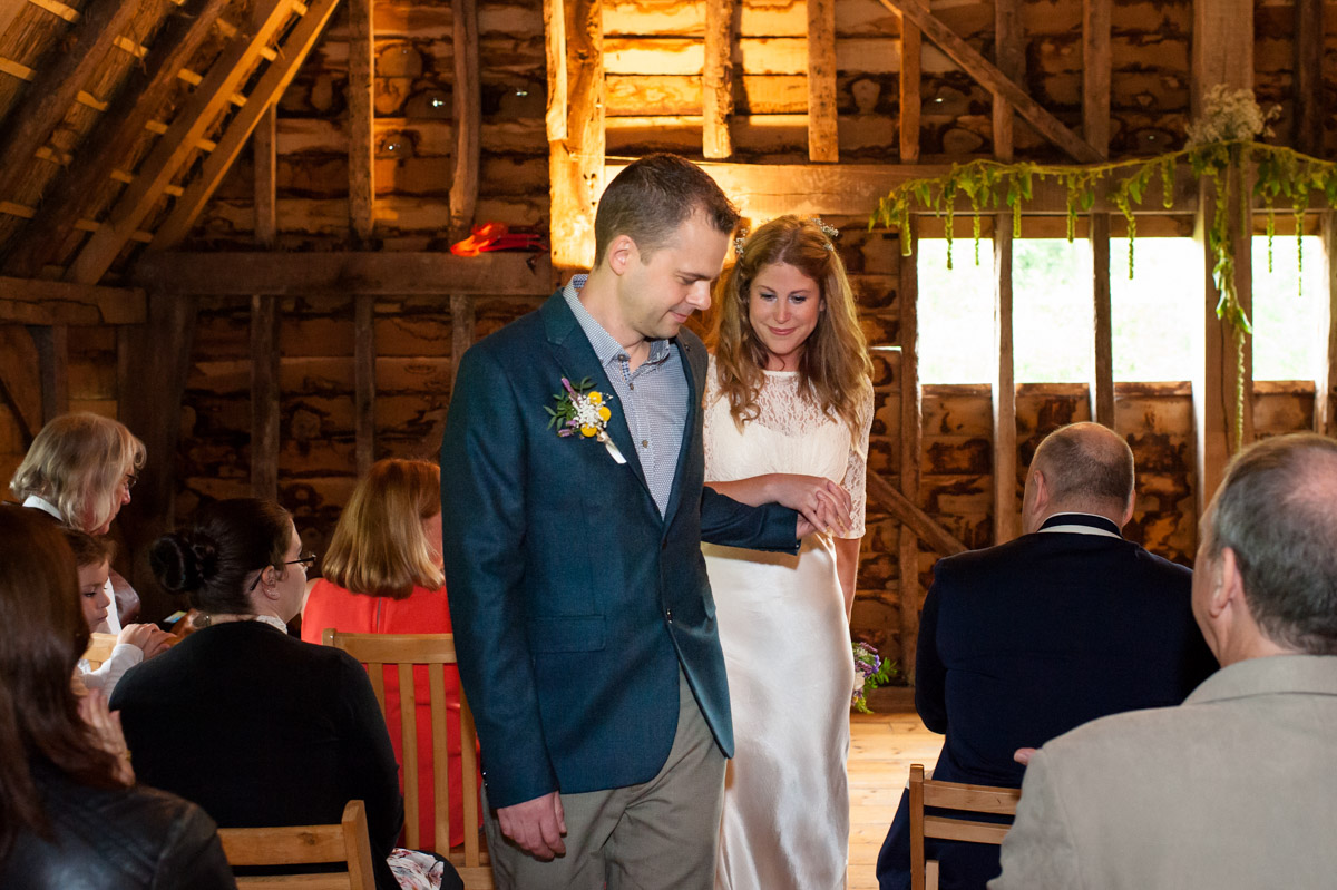 Doug and Corinne leave Ratsbury barn after wedding ceremony
