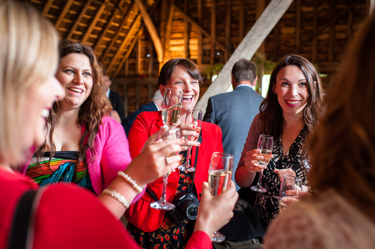 Wedding guests are photographed congratulating Corinne at her wedding at Ratsbury Barn in Kent