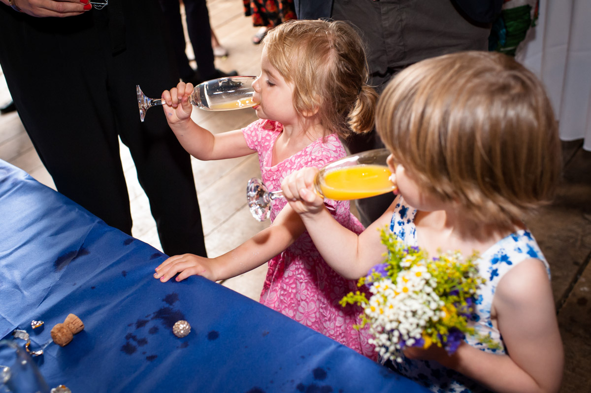 Children drink juice at Ratsbury barn wedding in Kent
