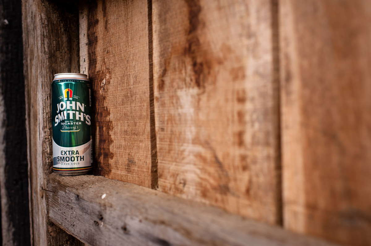 can of lager at Ratsbury barn placed on wooden door during wedding reception