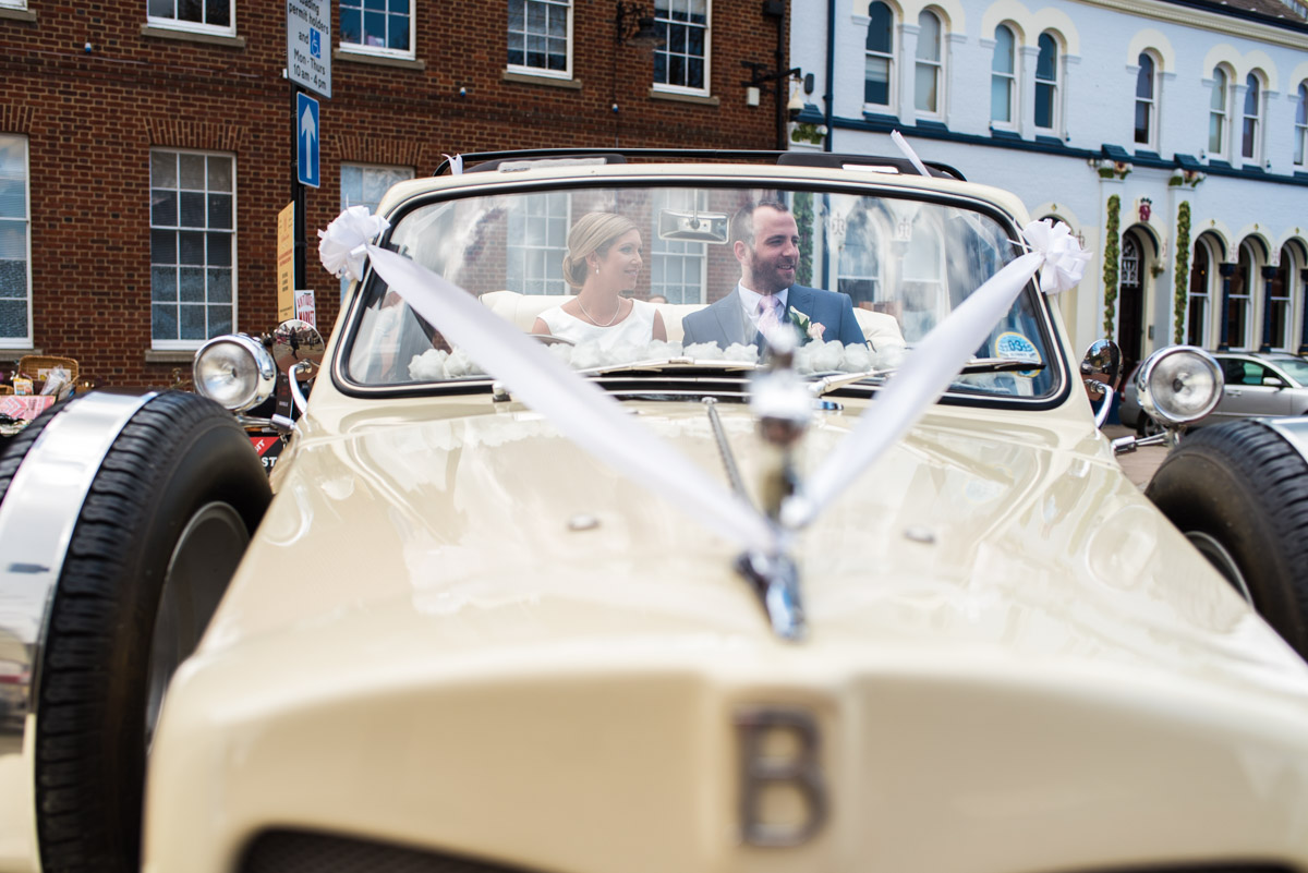 Photograph of Mike and Louise in their wedding car after the ceremony