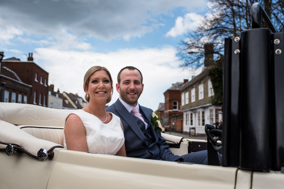 Louise and Mike photographed sitting in their wedding car in Faversham Kent