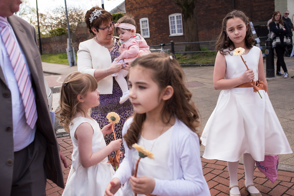 Bridesmaids and flower girls waiting for Louise to arrive for her Kent wedding in Faversham