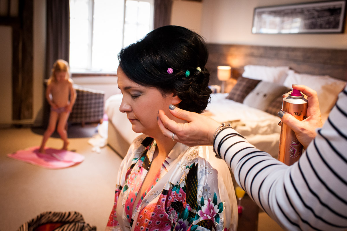 Laura is photographed having her wedding hair done