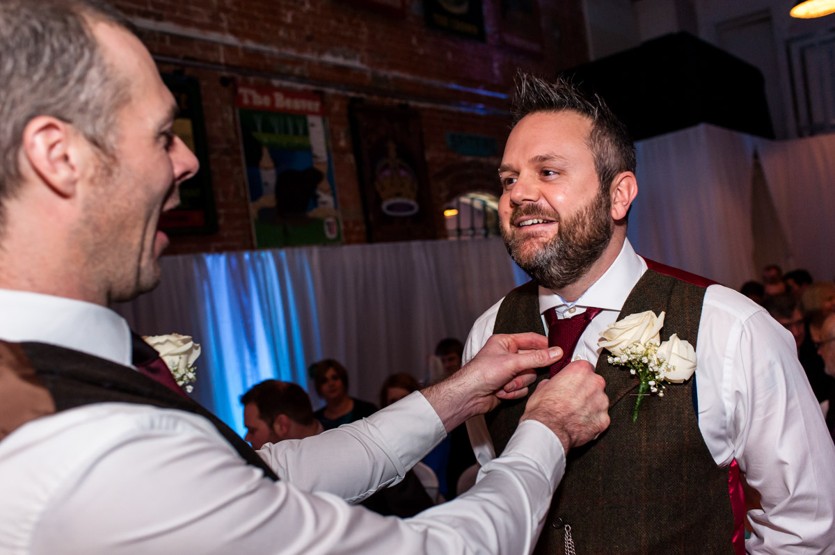 Daniel's best man adjusts his tie before his wedding ceremony begins