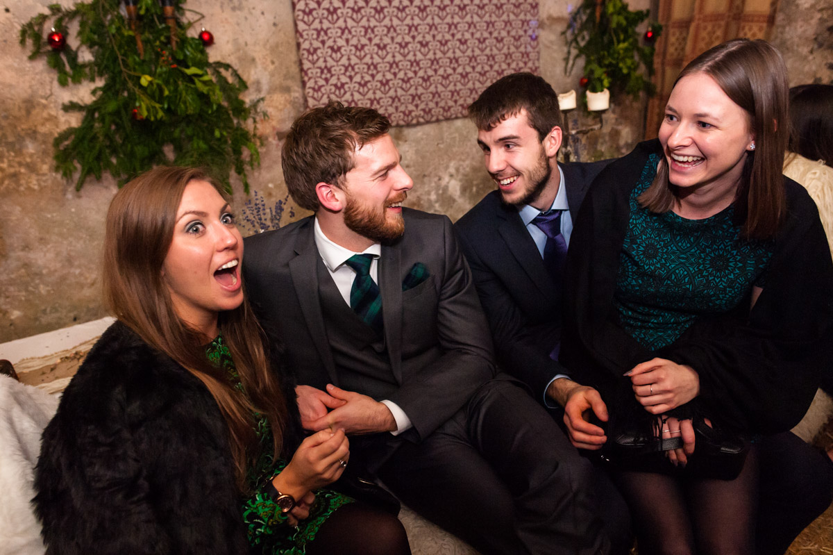 Friends enjoy a laugh together at Phil and sara's wedding reception at Dode in Kent