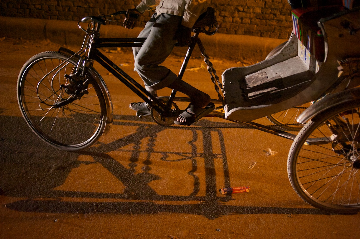 Photograph of shadows cast from rickshaw peddles in Varanasi