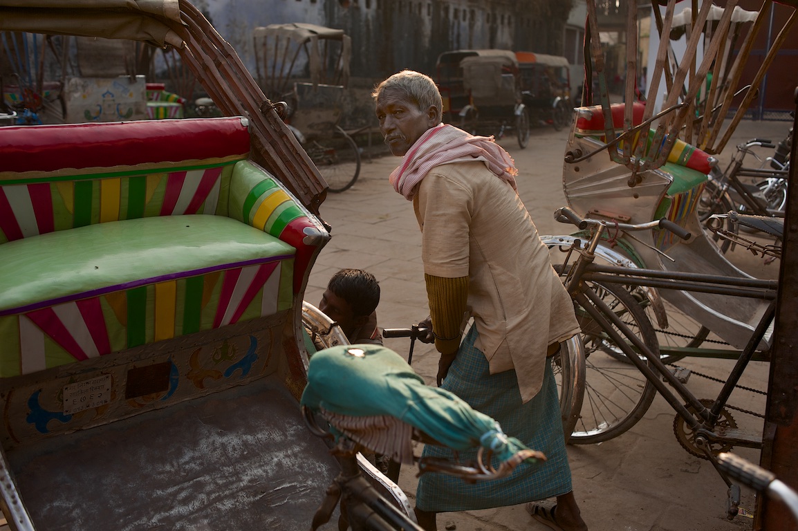 Photograph of rickshaws and people in India