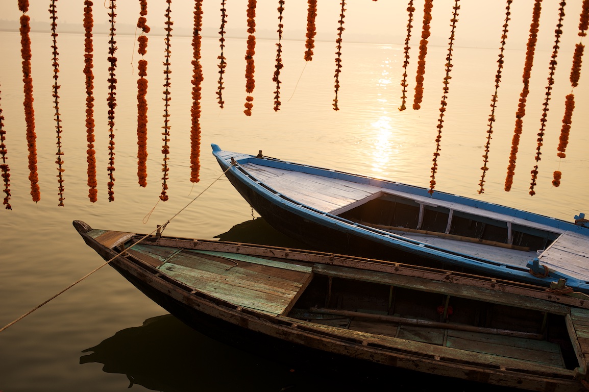 photograph of boats on ganges river in varanasi