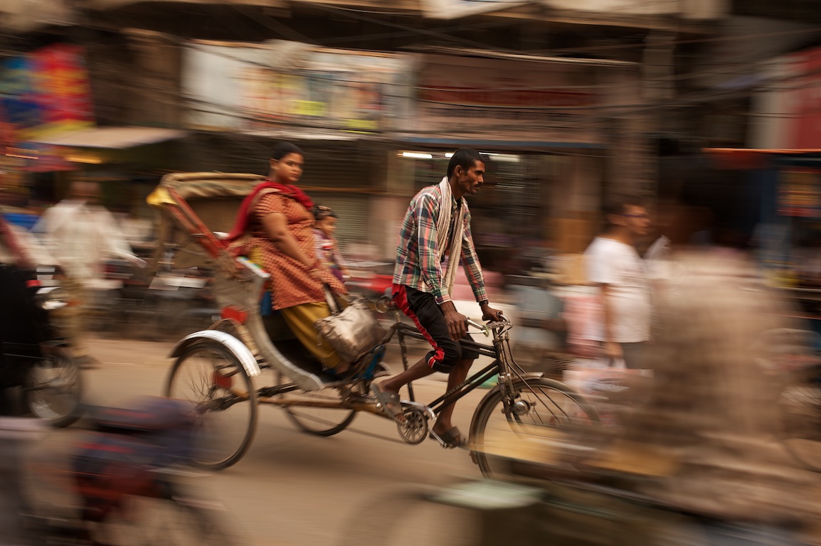 Photograph of rickshaw and female passenger