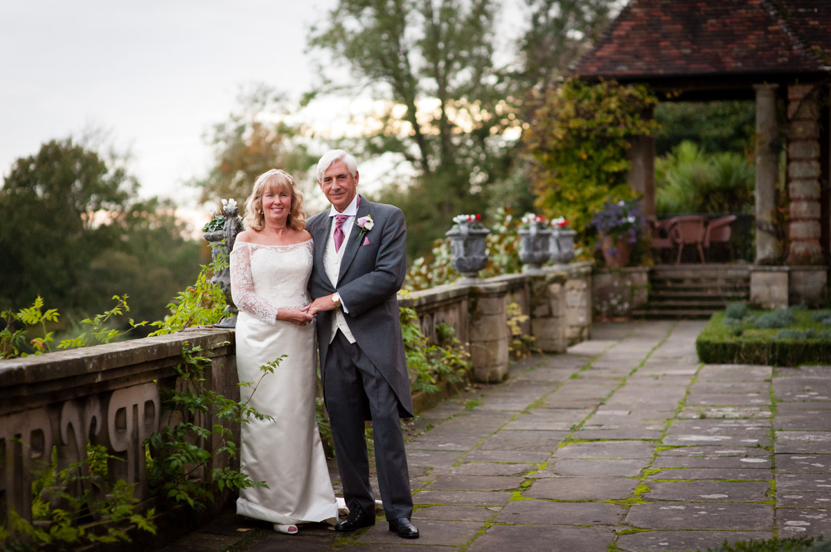 martine and dick photographed on the verander at port lymph mansion on their wedding day