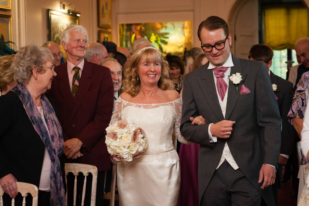 Martine is walked down the aisle by her son on her wedding day at Port Lympne Mansions in Kent