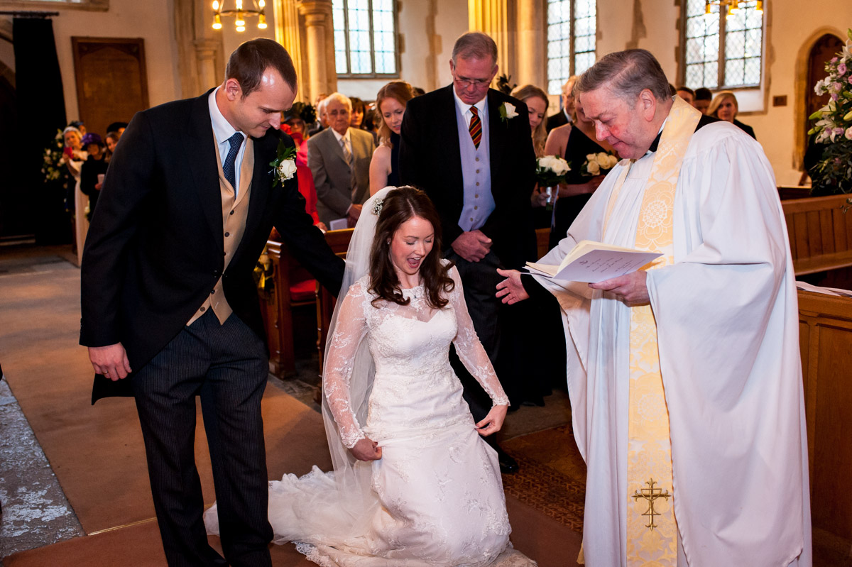 Emma kneels during her Kent church wedding